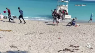 Migrants come ashore on beach in Jupiter