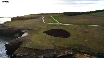 Drone footage shows a massive sinkhole revealing a hidden underground beach | SWNS