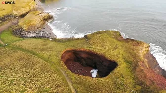 Drone footage shows a massive sinkhole revealing a hidden underground beach | SWNS