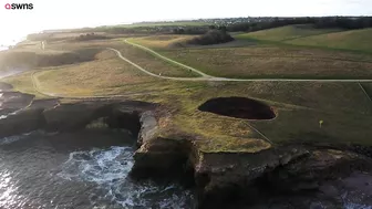 Drone footage shows a massive sinkhole revealing a hidden underground beach | SWNS