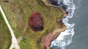 Drone footage shows a massive sinkhole revealing a hidden underground beach | SWNS