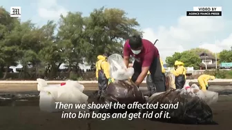 Workers scramble to clean oil slick from Thai beach