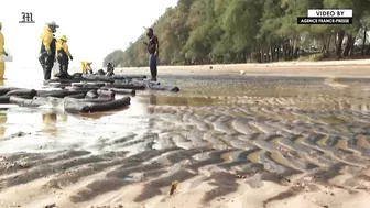 Workers scramble to clean oil slick from Thai beach