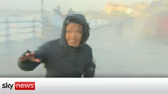 Storm Eunice: Sky correspondent gets hit by wave