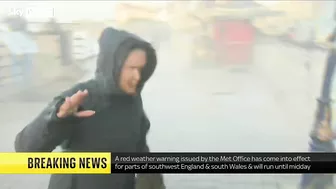 Storm Eunice: Sky correspondent gets hit by wave