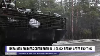 Ukrainian soldiers clear road in Lugansk region after fighting