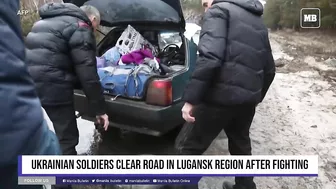 Ukrainian soldiers clear road in Lugansk region after fighting