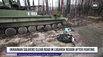 Ukrainian soldiers clear road in Lugansk region after fighting