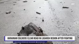 Ukrainian soldiers clear road in Lugansk region after fighting