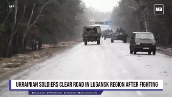 Ukrainian soldiers clear road in Lugansk region after fighting