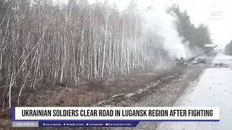 Ukrainian soldiers clear road in Lugansk region after fighting