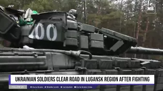 Ukrainian soldiers clear road in Lugansk region after fighting