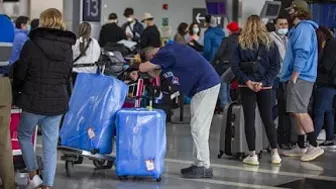 VERY EARLY ARRIVALS: Passengers try to beat airport security bottlenecks as travel ramps up