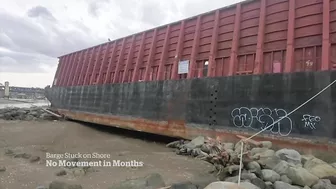 Barge beached in Vancouver’s English Bay not budging