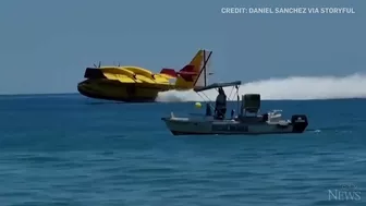 Europe wildfires: Water bomber refills off Spanish beach