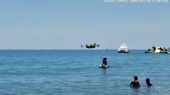 Europe wildfires: Water bomber refills off Spanish beach