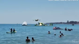 Europe wildfires: Water bomber refills off Spanish beach