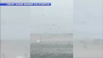 Storm sends umbrellas flying into ocean in Bethany Beach, Delaware