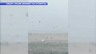 Storm sends umbrellas flying into ocean in Bethany Beach, Delaware