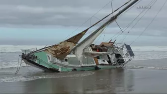 Capsized sailboat removed from shore near Rockaway Beach