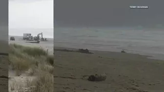 Capsized sailboat removed from shore near Rockaway Beach