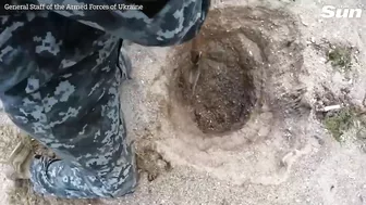 Ukrainian army destroys drifting sea mine with explosives on beach