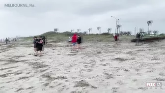 Hurricane Nicole: Weather tourists on Indialantic Beach in Melbourne, Florida