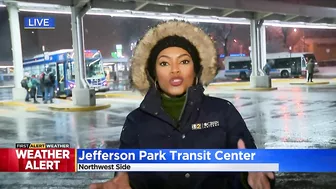 Commuters continuing routine travel as snow falls across Chicago