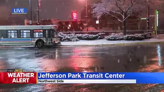 Commuters continuing routine travel as snow falls across Chicago