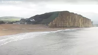 Moment massive chunk of West Bay cliff falls onto beach