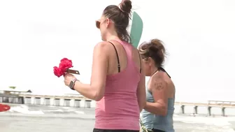 Surfers gather on Folly Beach to honor late bride