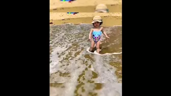 babies facing water waves on the beach ⛱️