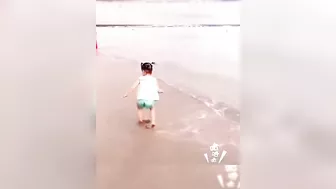 babies facing water waves on the beach ⛱️