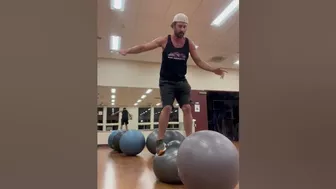 Man Hops From One Yoga Ball to Another - 1408462-6