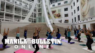 Yoga enthusiasts participate in yoga session at National Museum of Natural History