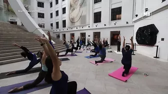 Yoga enthusiasts participate in yoga session at National Museum of Natural History