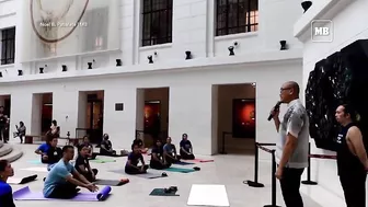 Yoga enthusiasts participate in yoga session at National Museum of Natural History