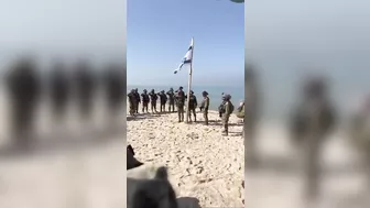 As really soldiers raise the flag on a beach in Gaza #israel