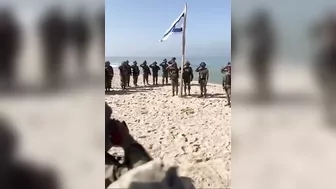 As really soldiers raise the flag on a beach in Gaza #israel