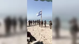 As really soldiers raise the flag on a beach in Gaza #israel