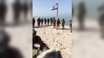 As really soldiers raise the flag on a beach in Gaza #israel