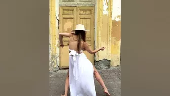 Flexible dance in a white dress on the street